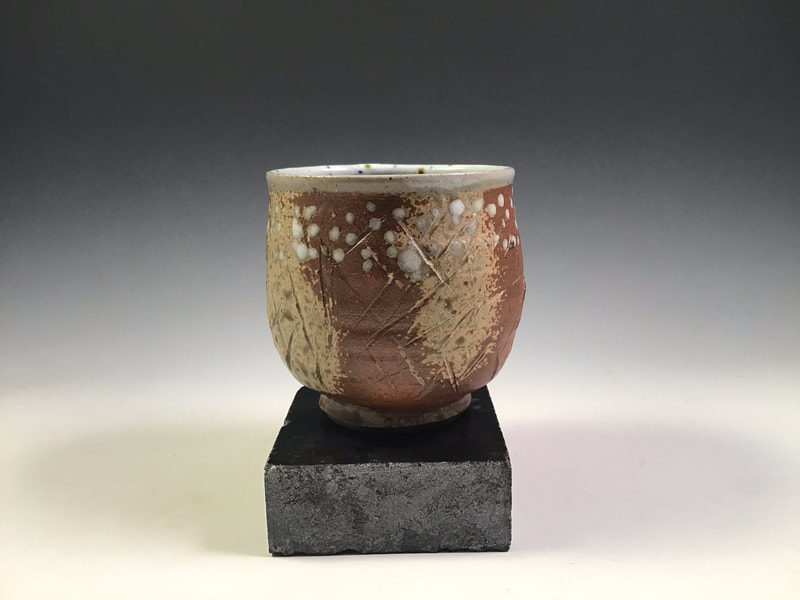 Tea bowl with incised marks and dots, wood ash spray, signed, cone 10 in propane reduction. Signed.
$68 includes shipping to L48.
Contact Simon at: simonleachpottery@gmail.com